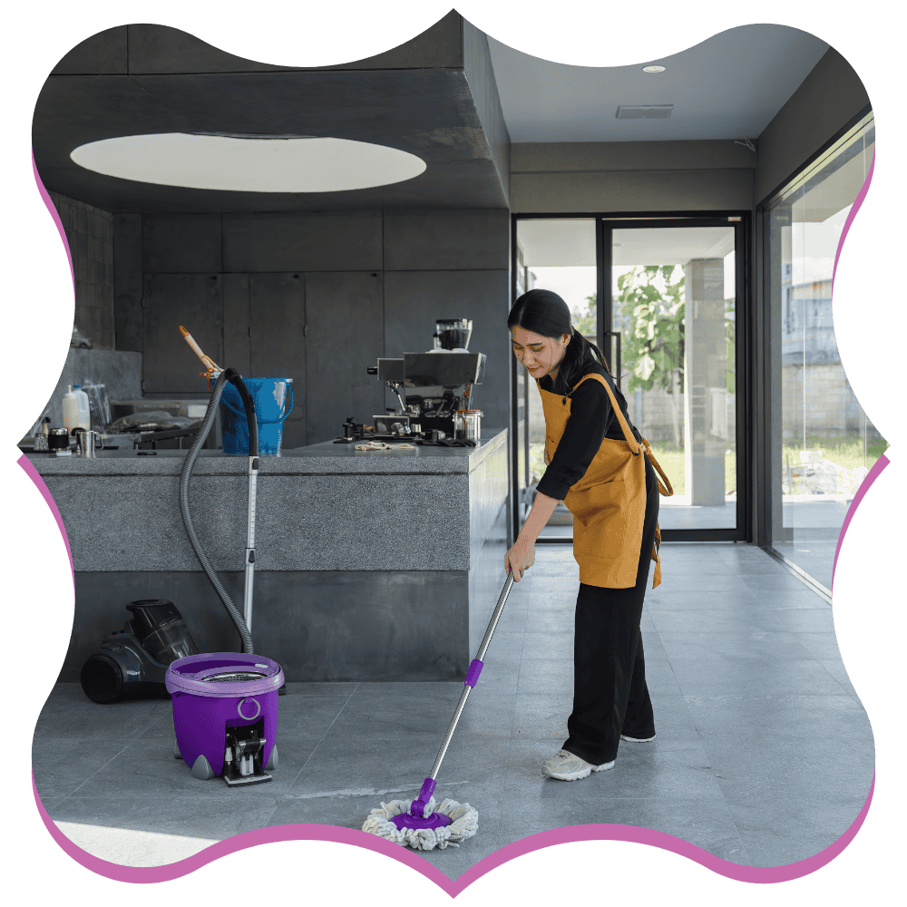 Professional cleaner mopping a cement floor after post-construction debris removal